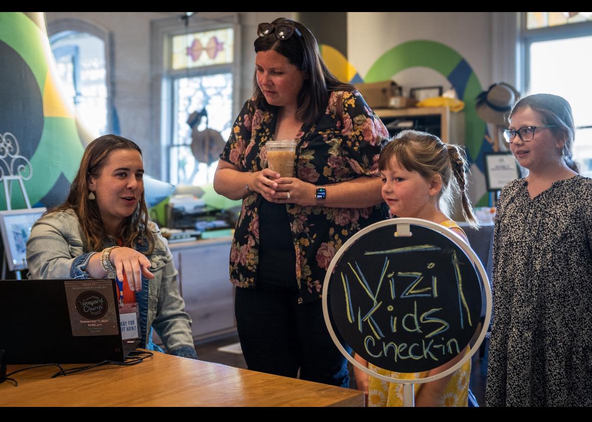 Families at ViZi Kids check-in